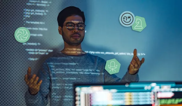 Homme devant un écran projetant du code, illustrant le métier de prompt engineer