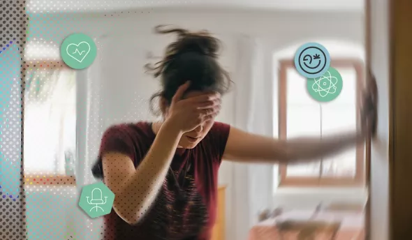 Femme floue se tenant à un mur, la main sur le front, symbolisant le stress