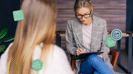 Une manager en pleine discussion avec une collaboratrice, prenant des notes